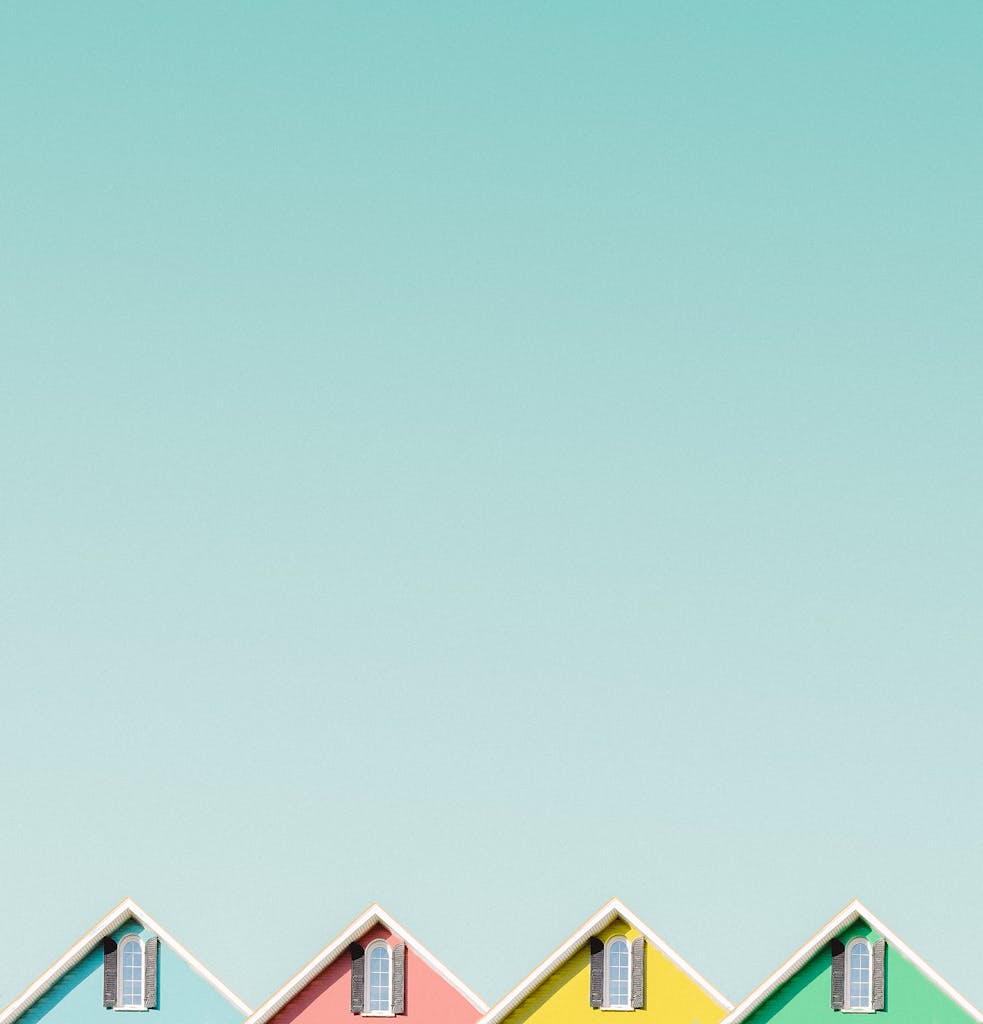 Aesthetic view of vibrant house roofs under a clear turquoise sky in Buffalo, NY.