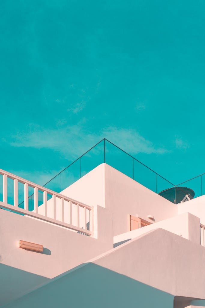 Explore the clean lines of modern Cycladic architecture under a clear blue sky in Platis Gialos, Greece.