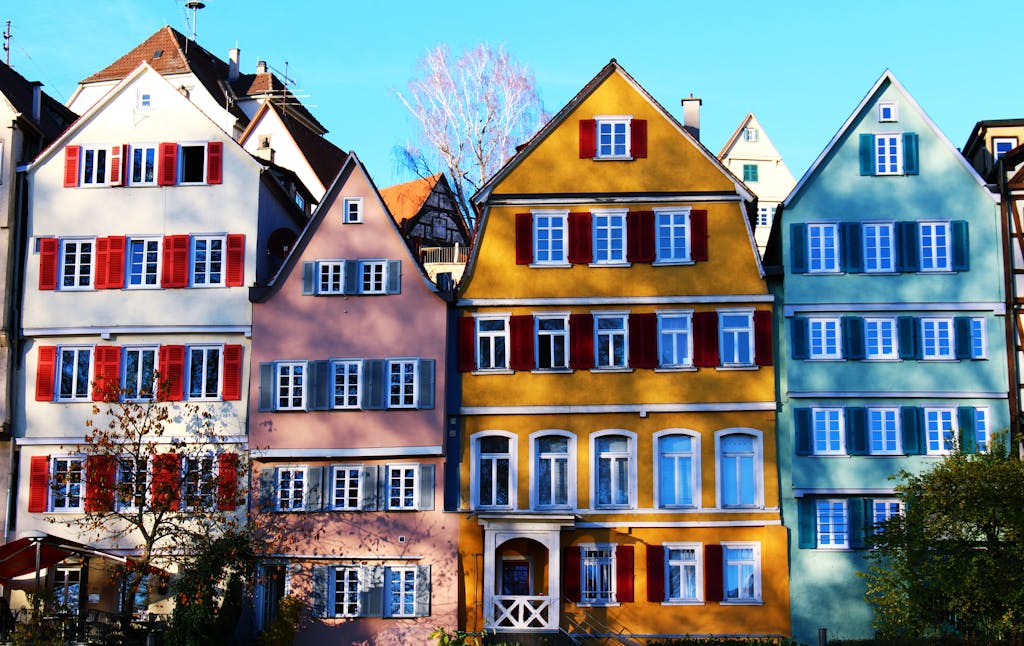 Vibrant facades of traditional houses in Tübingen's historic center, under a clear daytime sky.